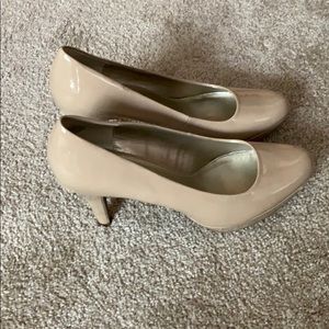 A pair of medium height nude heels.